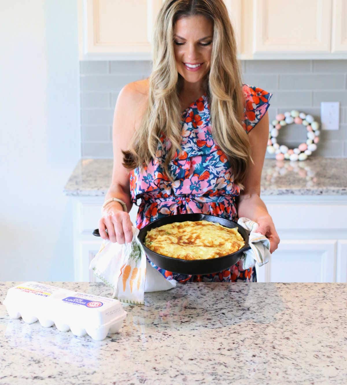 Delightful Mom Food Holding A Healthy Frittata Recipe in a Pan With Eggs on the Counter