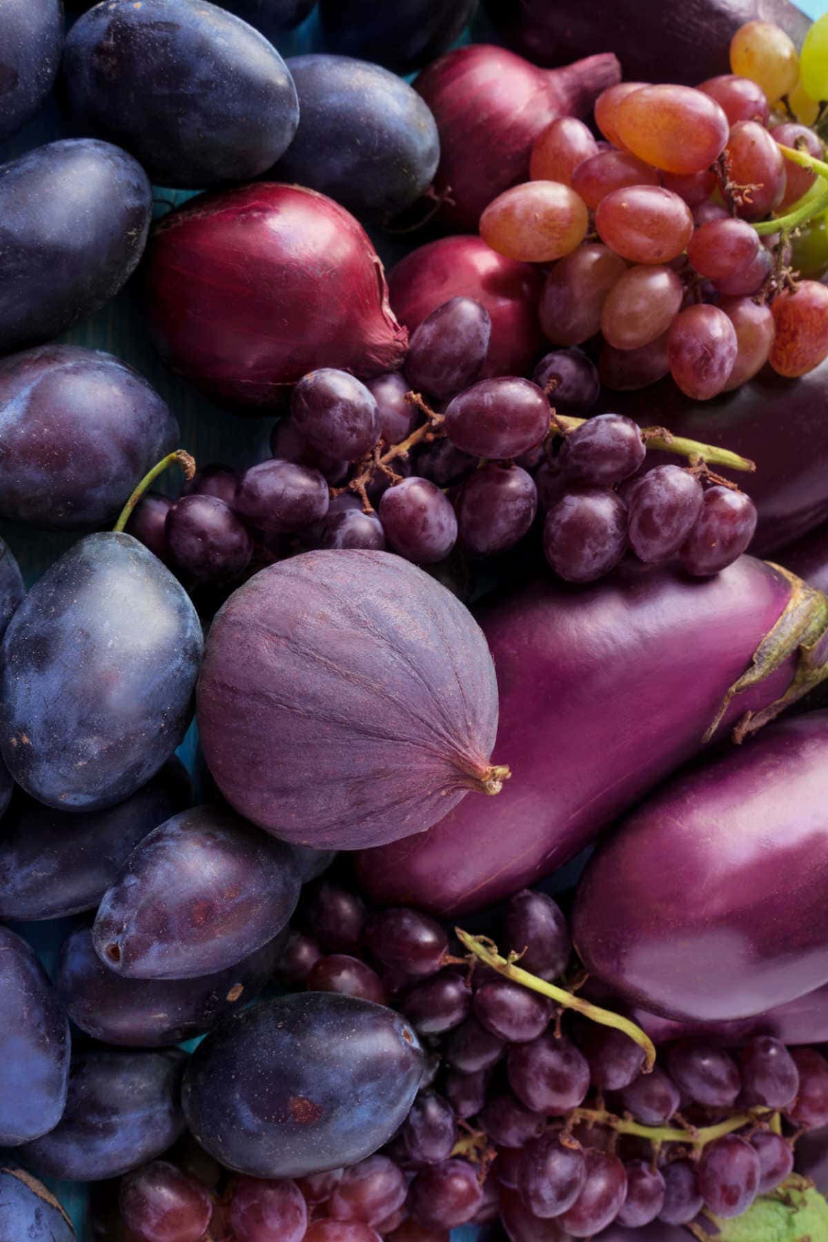Purple fruits of grapes, eggplant, figs, plums.