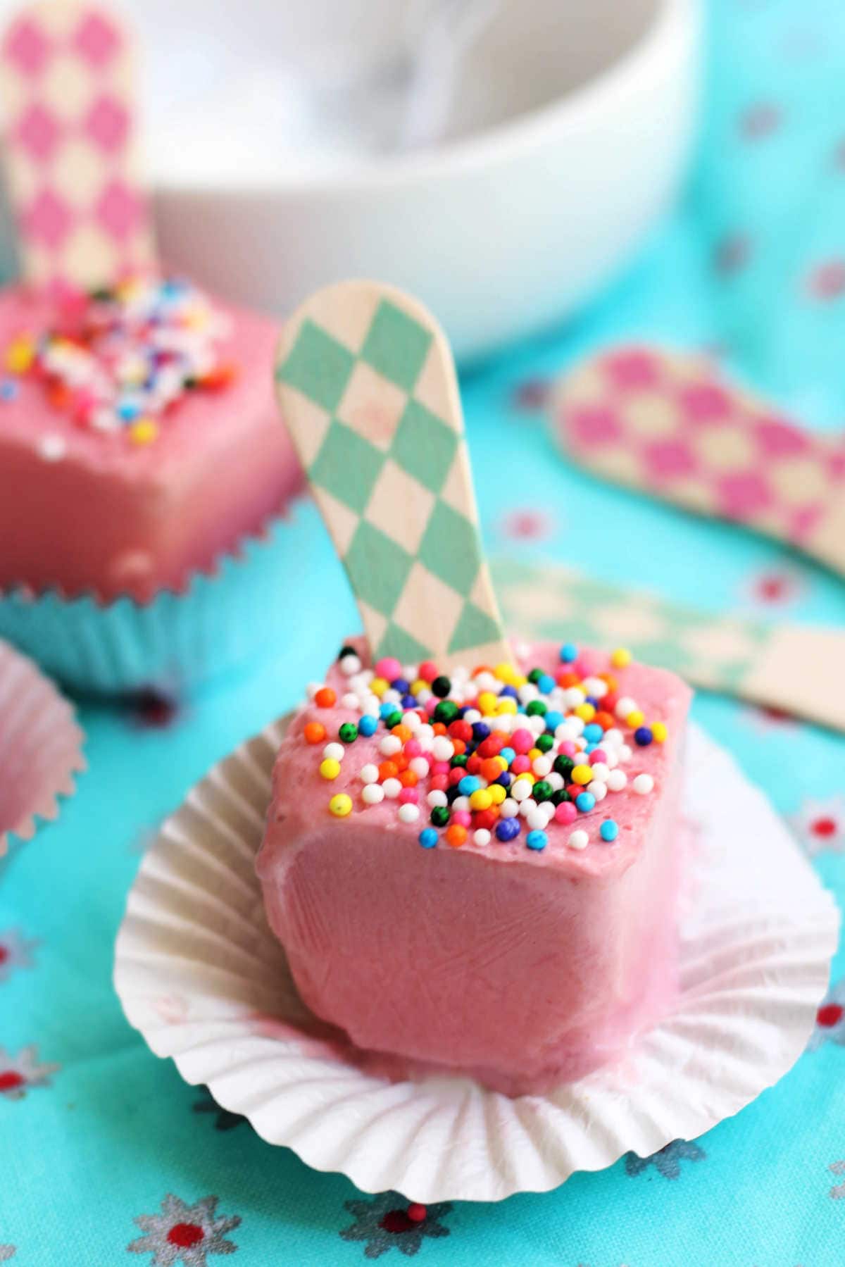 Close-up of Creamy Strawberry Popsicles in a Muffin Cup Liner on a Table