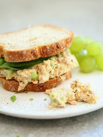 Vegan chickpea tuna salad on bread with lettuce.