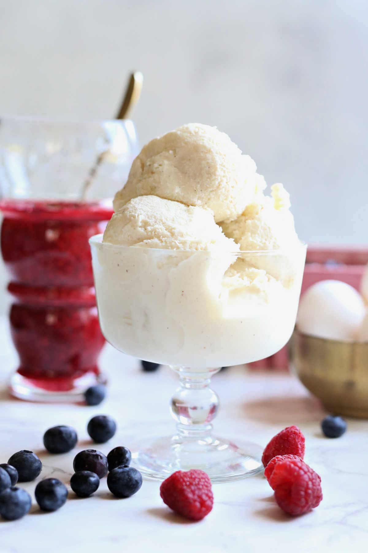 Coconut milk ice cream in a dish with fresh berries.