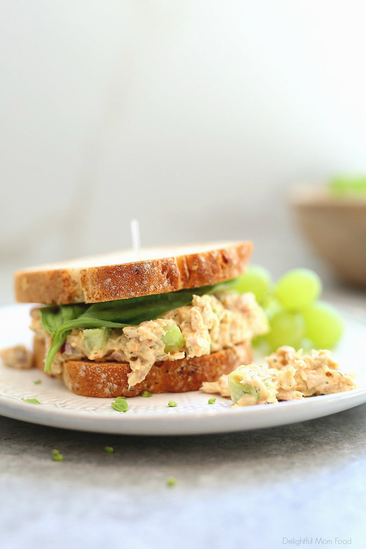 Chickpea Tuna Salad Sandwich on a Plate with Green Grapes.