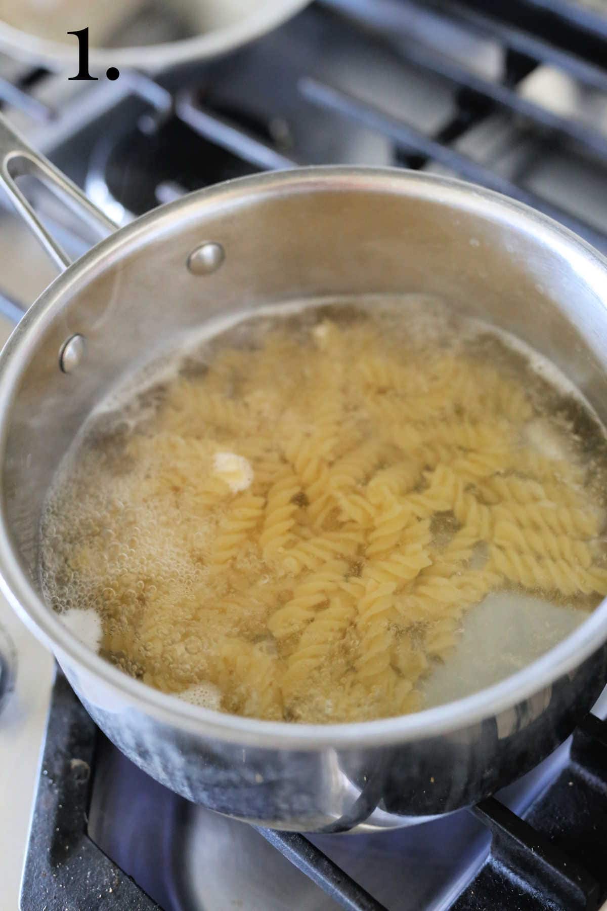 Boiling noodles in a sauce pan.