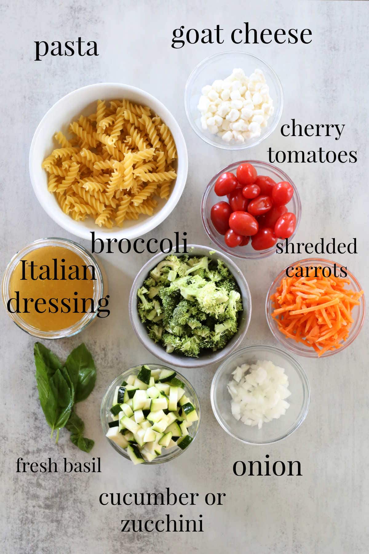 Ingredients for pasta salad recipe with Italian salad dressing.