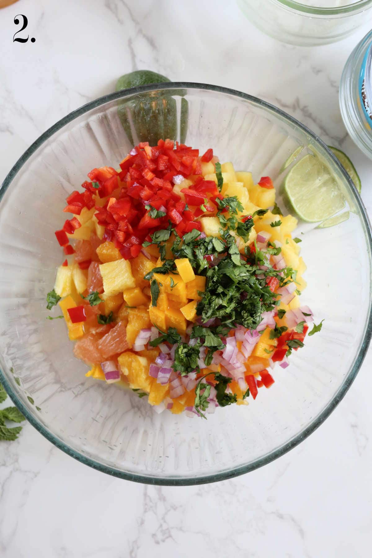 Citrus salsa with orange fruit and grapefruit in a mixing bowl.