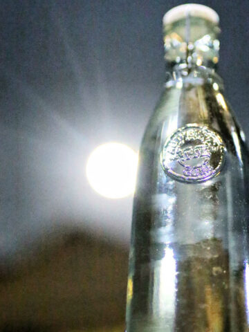 Full moon water being charged in a glass bottle by the moon.