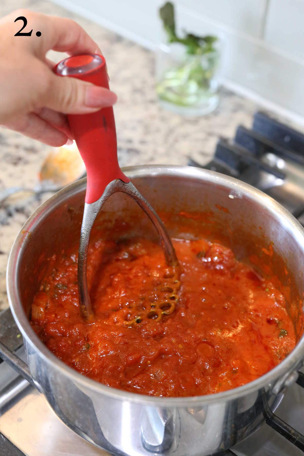 Making marinara sauce in a saucepan on the stove.