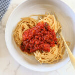 Marinara sauce on gluten-free pasta in a bowl.