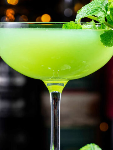 Green cocktails in a glass with fresh mint.