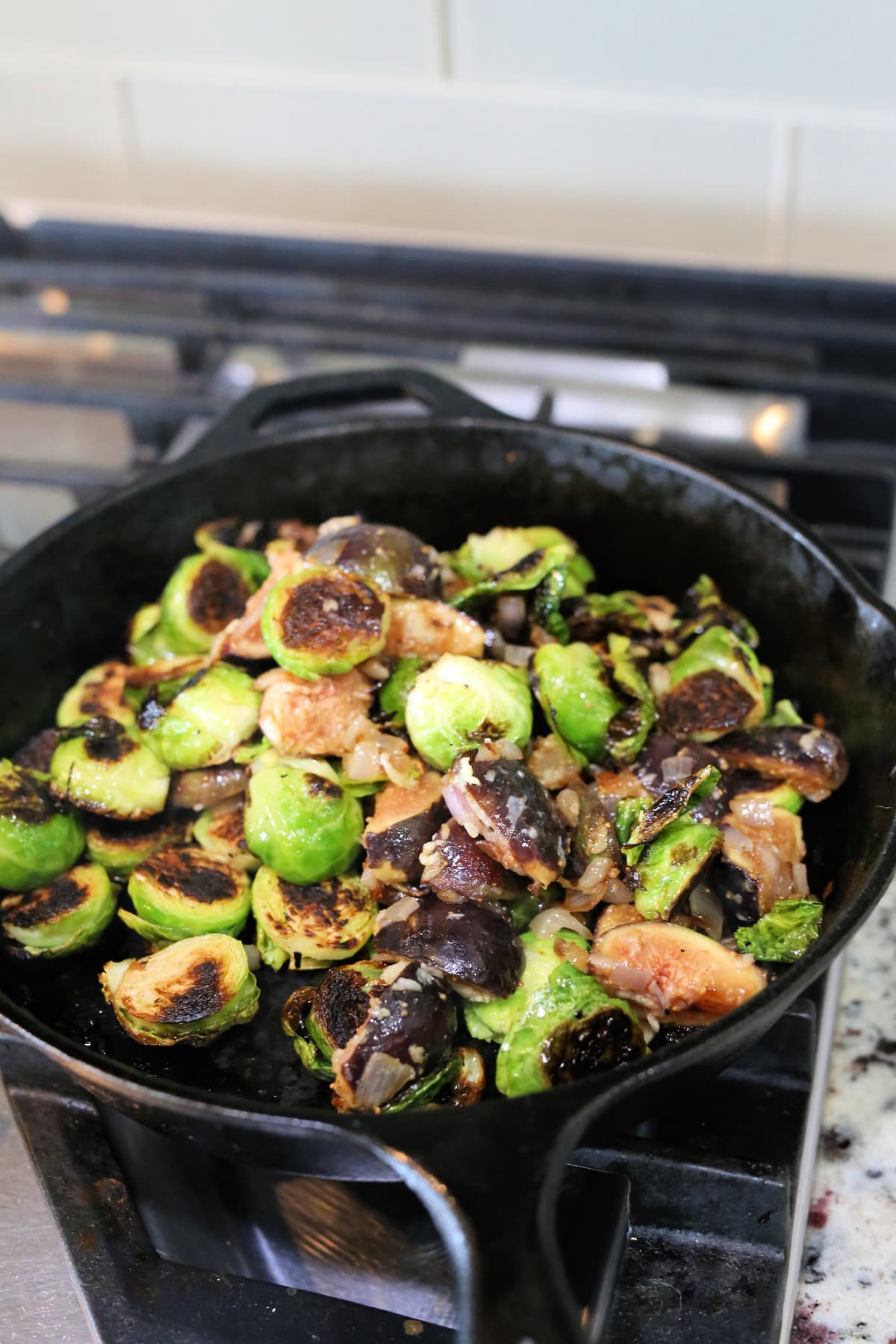 Brussels Sprouts, fig, and shallots fried in a cast iron skillet.
