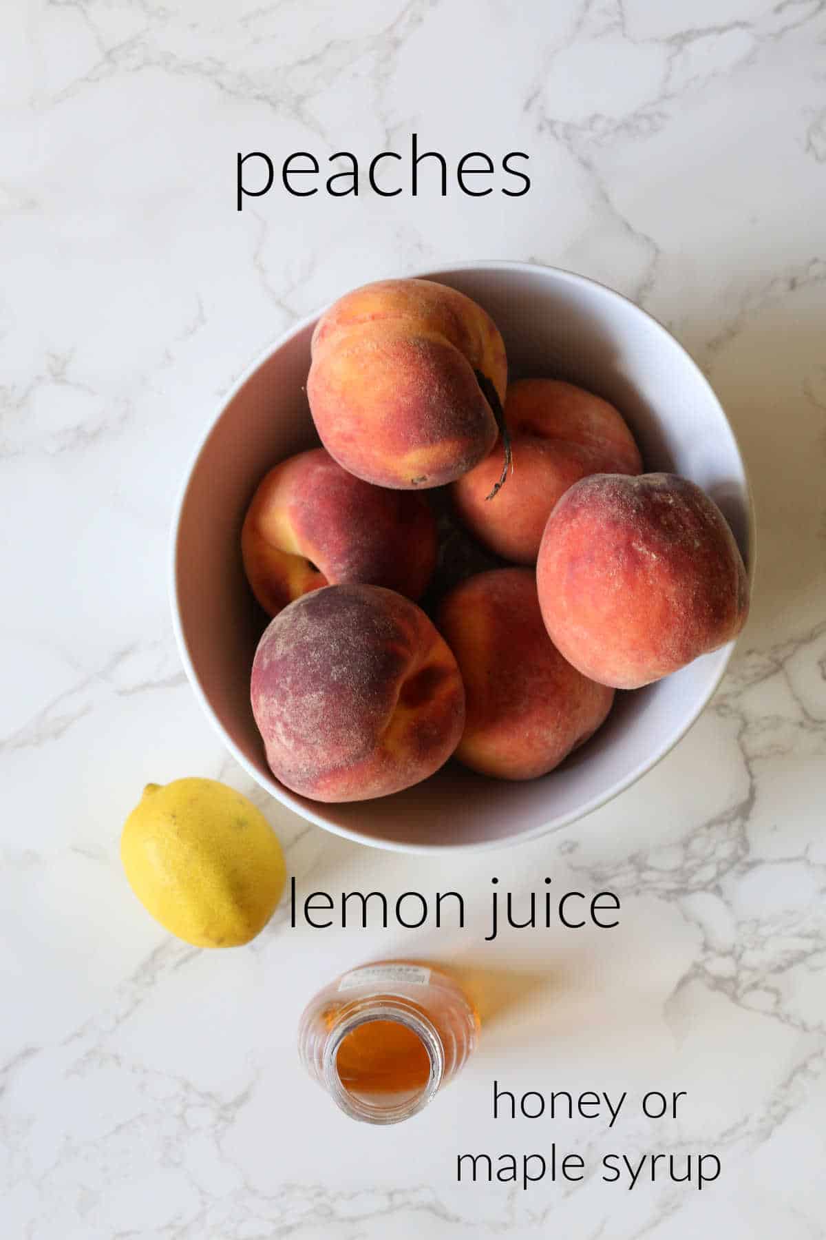 Peaches, lemon, honey on a counter.