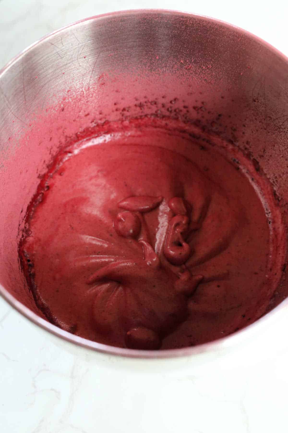 Beet souffle in a mixing bowl before baking.