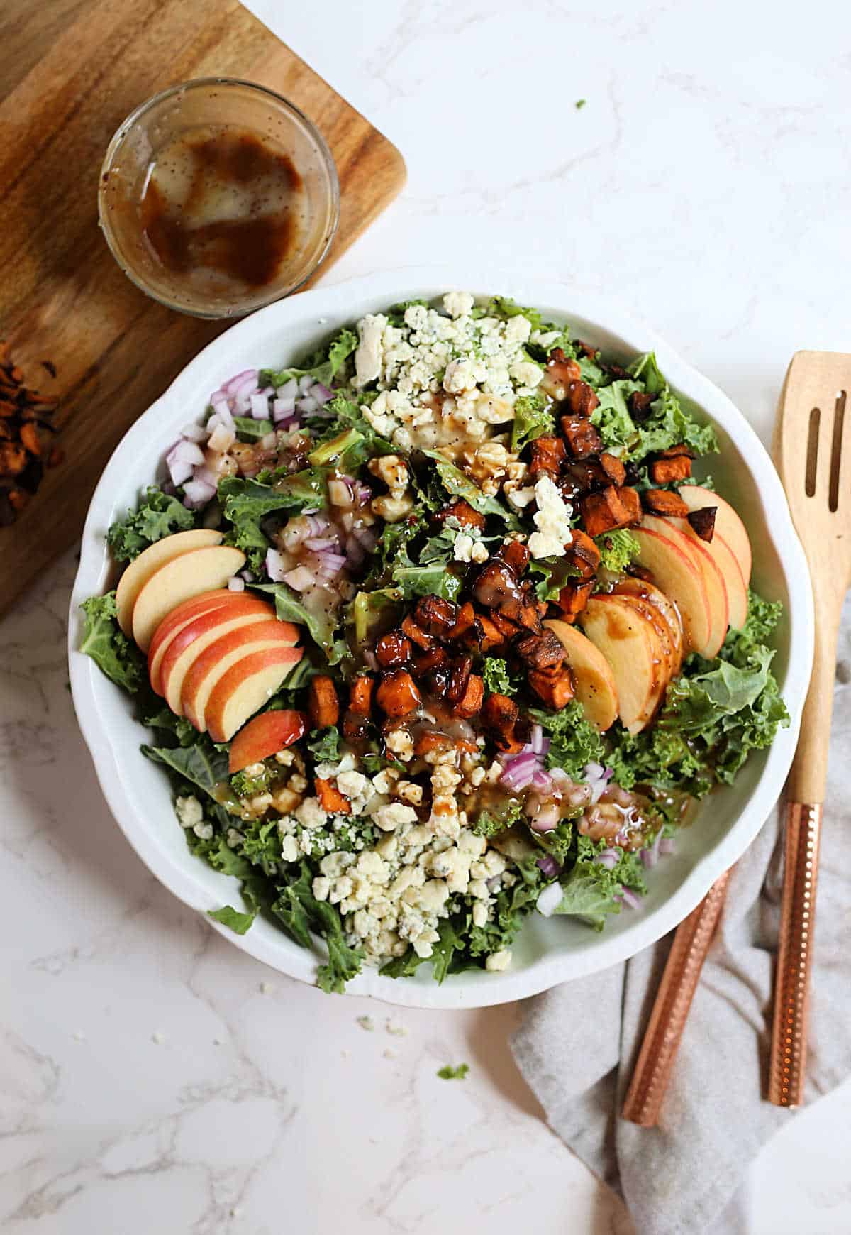 Kale salad with apples blue cheese walnuts and sweet potatoes.