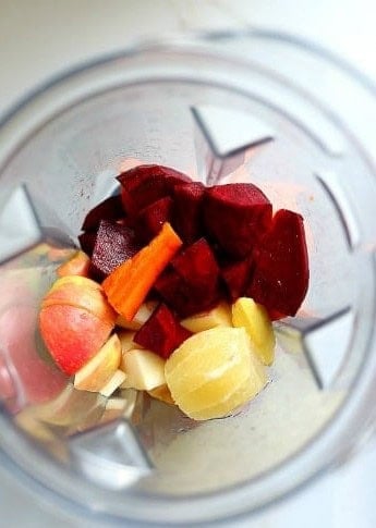 Chopped beets, carrots, apple, ginger and lemon in a blender.