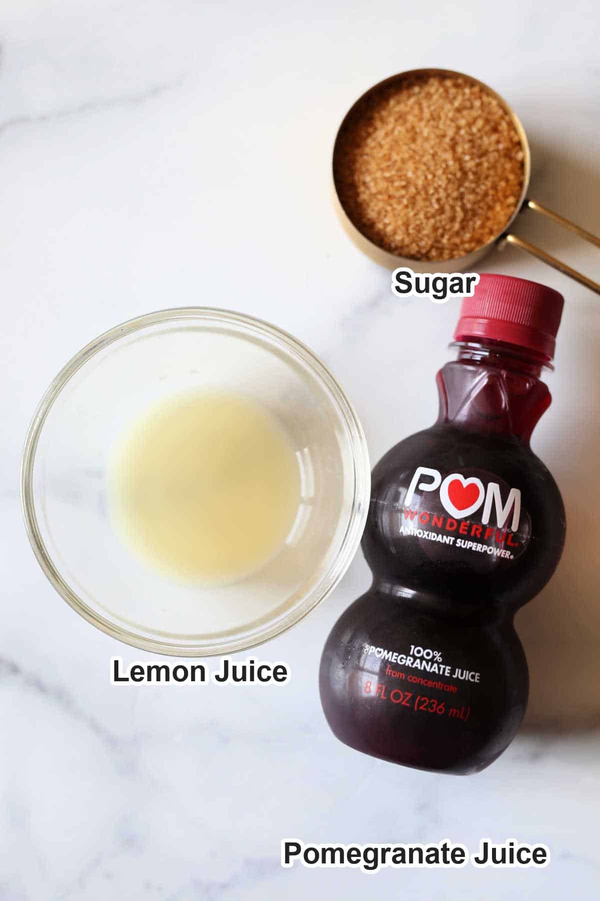 Labeled ingredients for grenadine syrup: pomegranate juice, sugar and lemon juice.