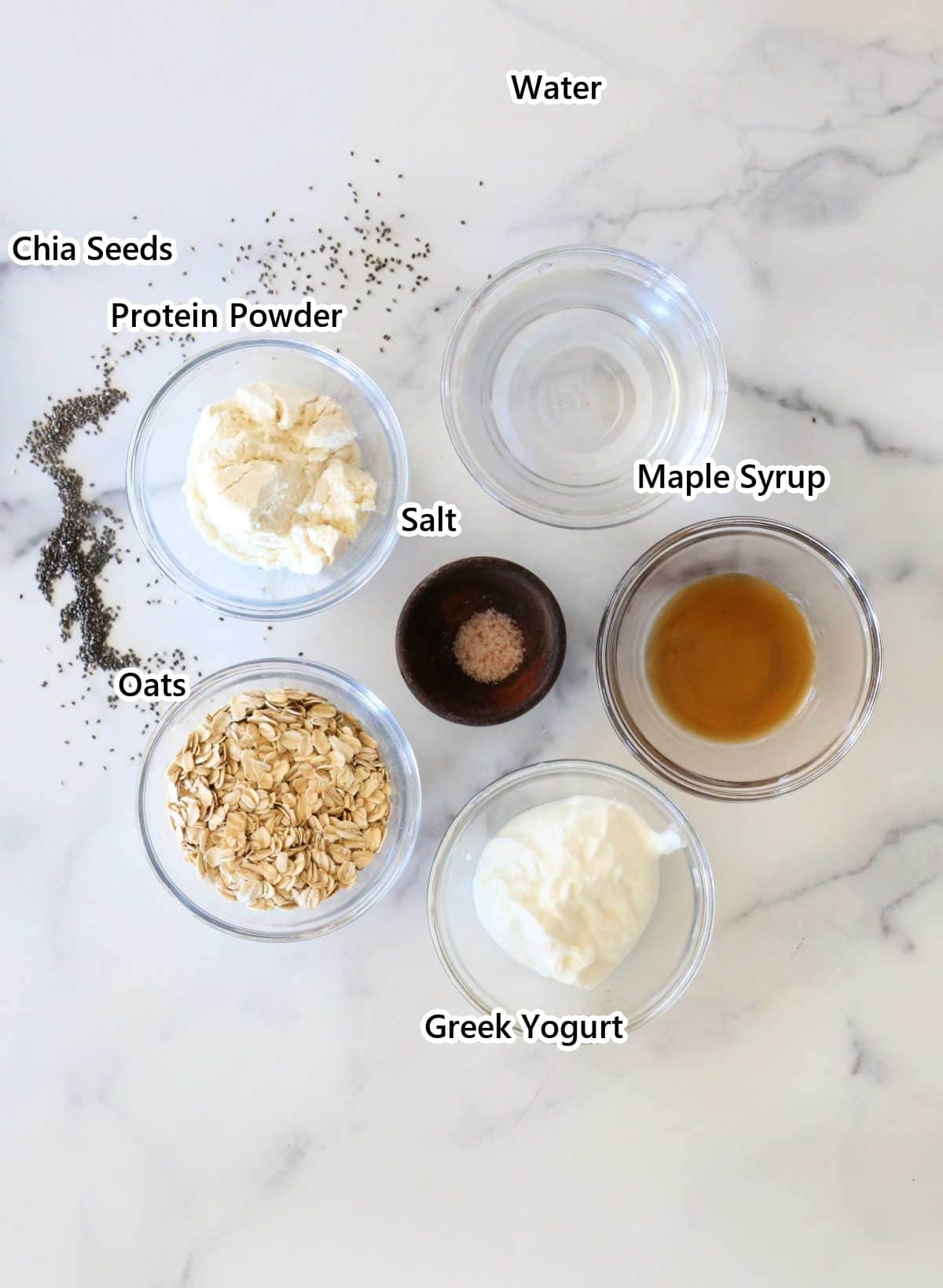 Labeled ingredients for high protein oatmeal: oats, protein powder, Greek yogurt, chia seeds, maple syrup, salt and water.