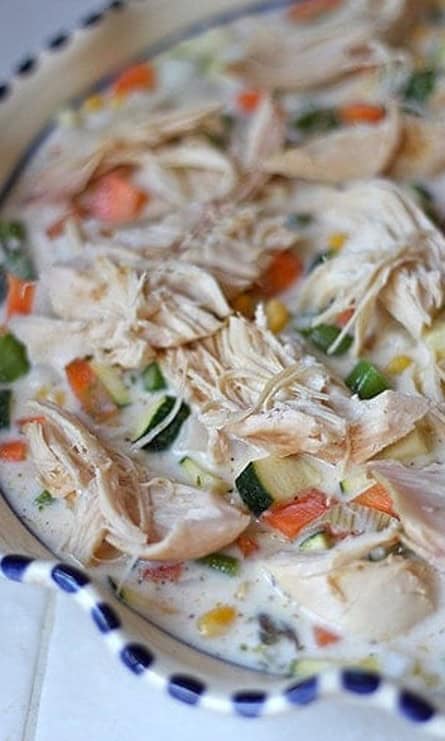 Creamy vegetable and shredded chicken filling in a pie dish.