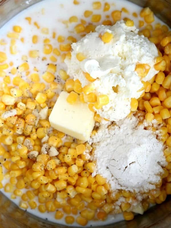 Corn, milk, cream cheese, butter, flour and garlic in a saucepan before stirring.